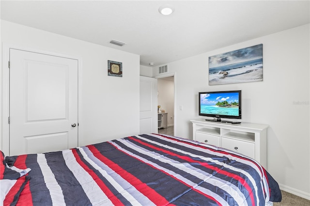 bedroom with carpet flooring, visible vents, and baseboards