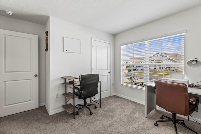 office with light colored carpet, a textured ceiling, and baseboards