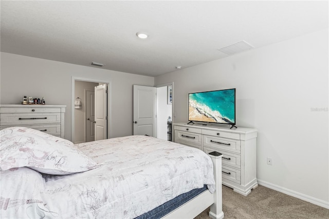 bedroom with light carpet, visible vents, and baseboards