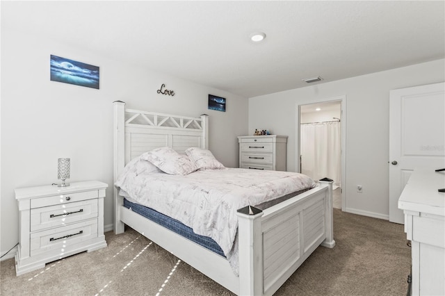 bedroom with visible vents, dark carpet, and baseboards