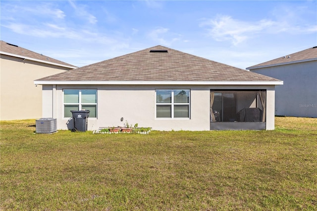 back of property featuring roof with shingles, stucco siding, a lawn, a sunroom, and central AC