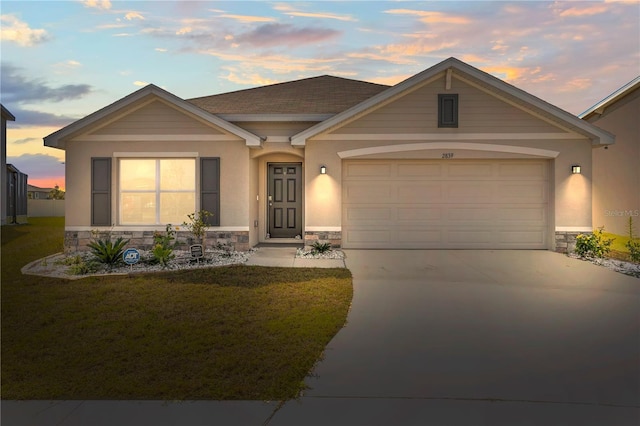 view of front of house featuring stone siding, a front yard, and driveway