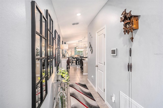 hall featuring light tile patterned floors