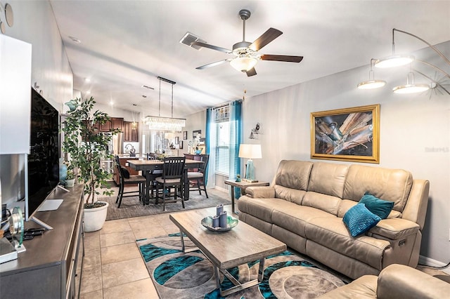 living room featuring light tile patterned floors and ceiling fan