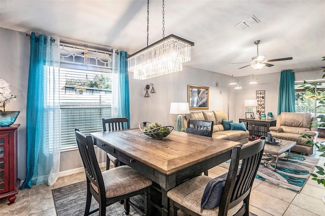 tiled dining area with ceiling fan