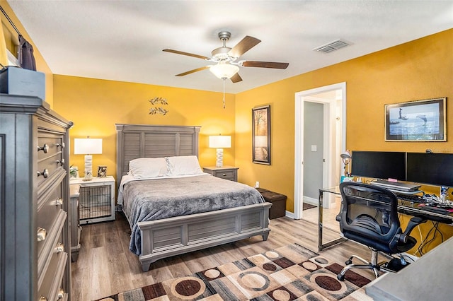 bedroom with wood-type flooring and ceiling fan