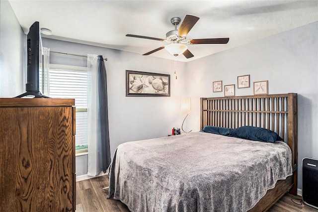 bedroom featuring dark hardwood / wood-style floors and ceiling fan