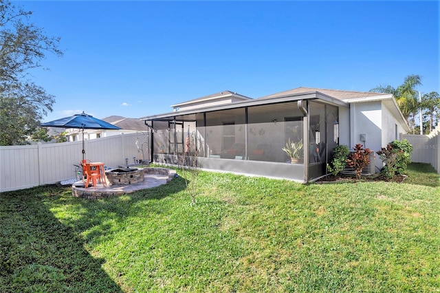 view of yard featuring a sunroom and a fire pit