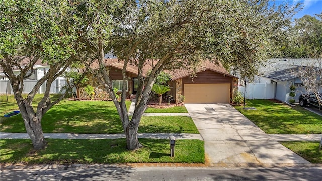 obstructed view of property with a garage and a front yard