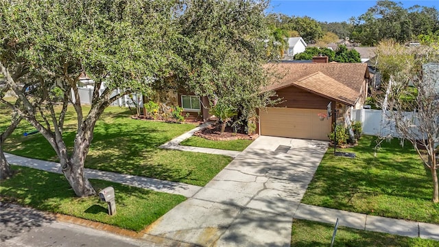 view of front of house featuring a garage and a front lawn