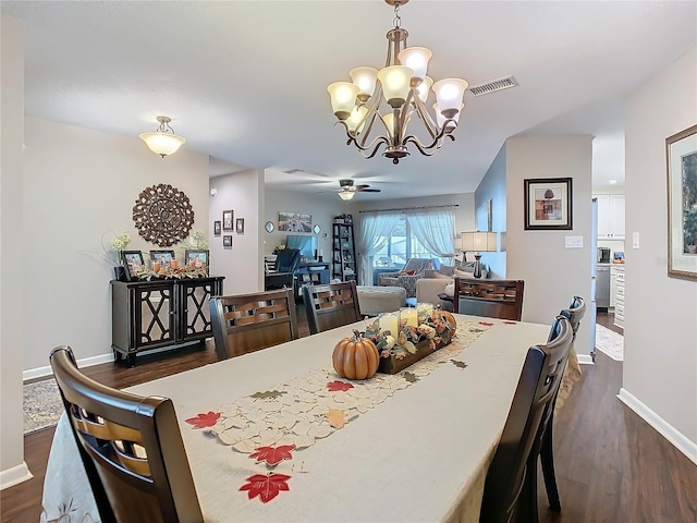 dining room featuring dark wood-type flooring and ceiling fan with notable chandelier