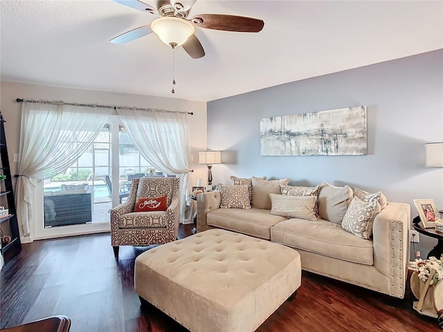 living room featuring ceiling fan and dark hardwood / wood-style floors