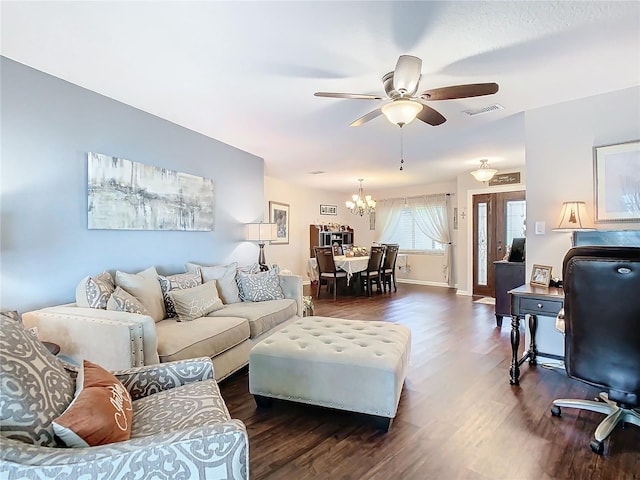 living room with dark hardwood / wood-style floors and ceiling fan with notable chandelier