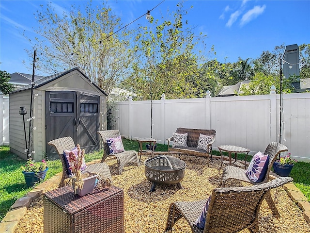 view of patio / terrace featuring a storage shed and an outdoor fire pit