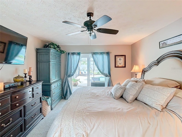 carpeted bedroom featuring ceiling fan, access to outside, and a textured ceiling