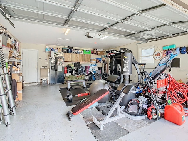 garage with black refrigerator with ice dispenser