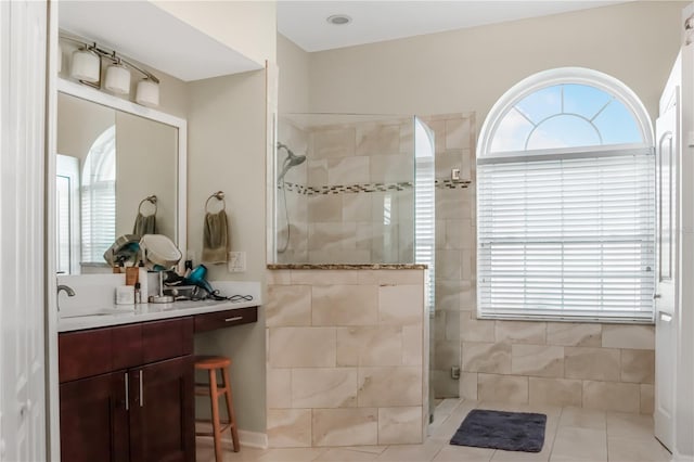 bathroom featuring vanity and tiled shower