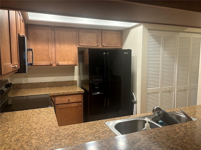 kitchen featuring sink and black appliances