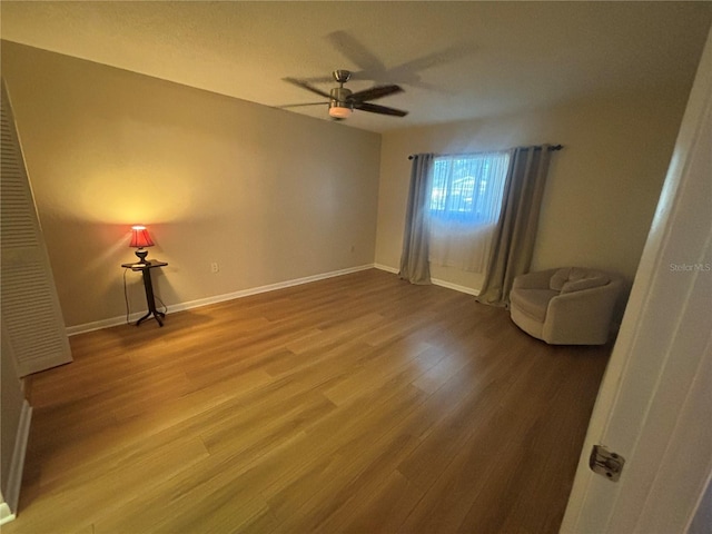 spare room with hardwood / wood-style floors and ceiling fan