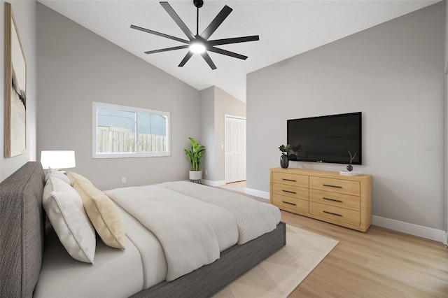 bedroom with lofted ceiling, light hardwood / wood-style floors, a closet, and ceiling fan