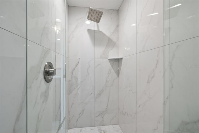 bathroom with a tile shower