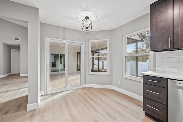 unfurnished dining area with light wood-type flooring