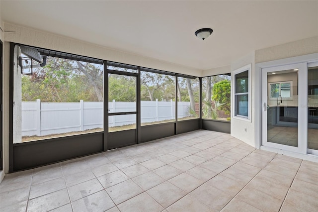 unfurnished sunroom with sink