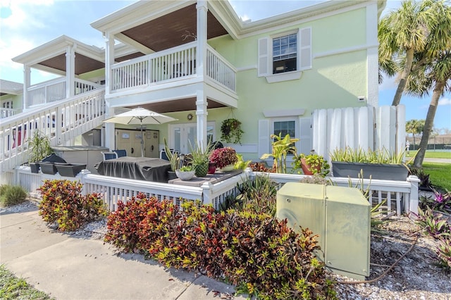 rear view of property featuring a balcony