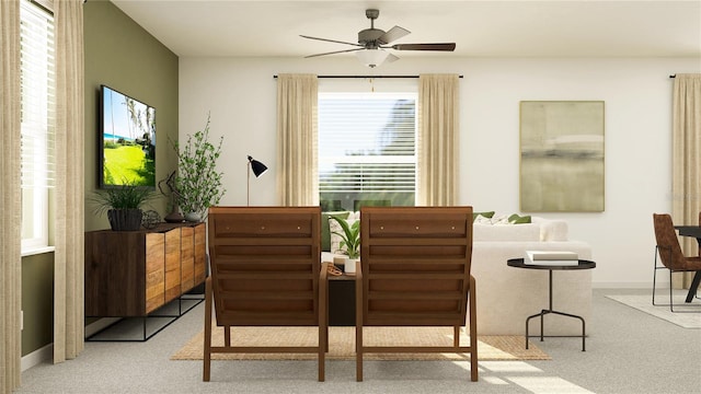 sitting room with light colored carpet and ceiling fan