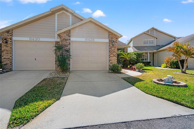 view of front of property with a garage and a front lawn