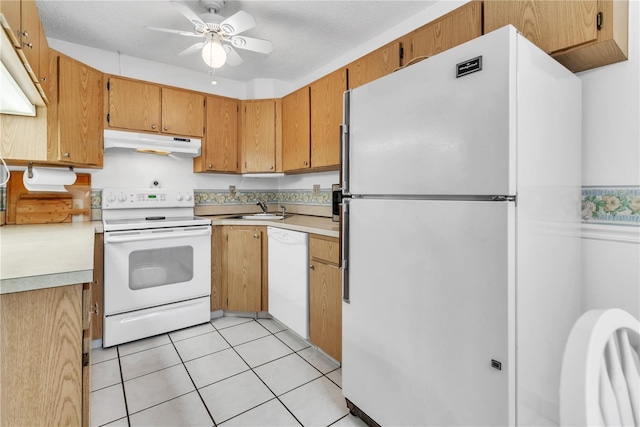 kitchen with sink, light tile patterned floors, white appliances, ceiling fan, and a textured ceiling