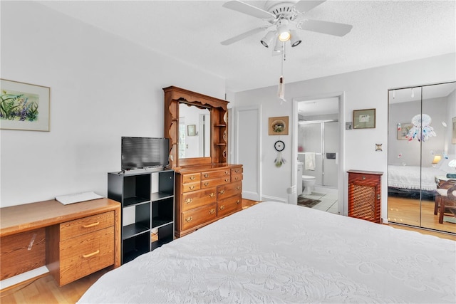 bedroom featuring ceiling fan, ensuite bathroom, a textured ceiling, and light hardwood / wood-style flooring