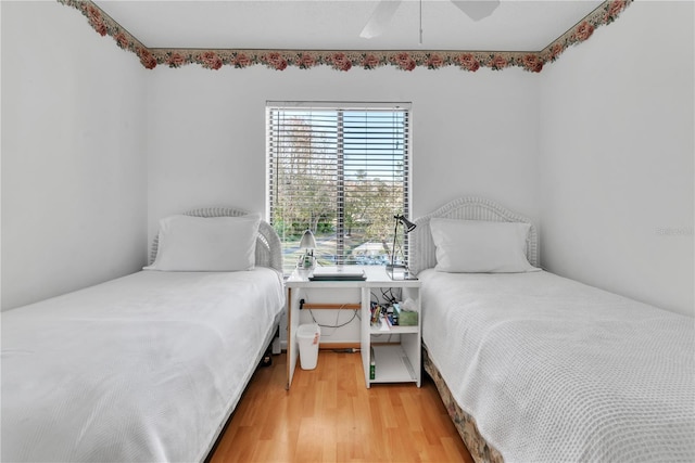 bedroom with wood-type flooring and ceiling fan