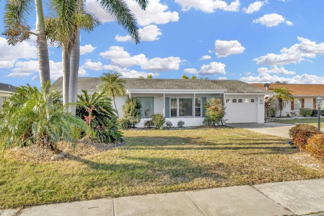 ranch-style home with a garage and a front lawn