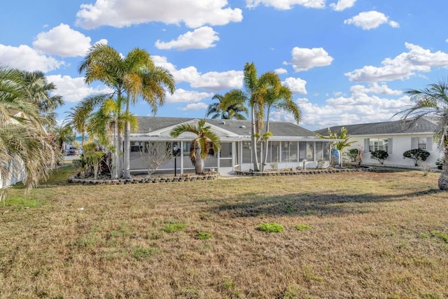 ranch-style house with a sunroom and a front lawn