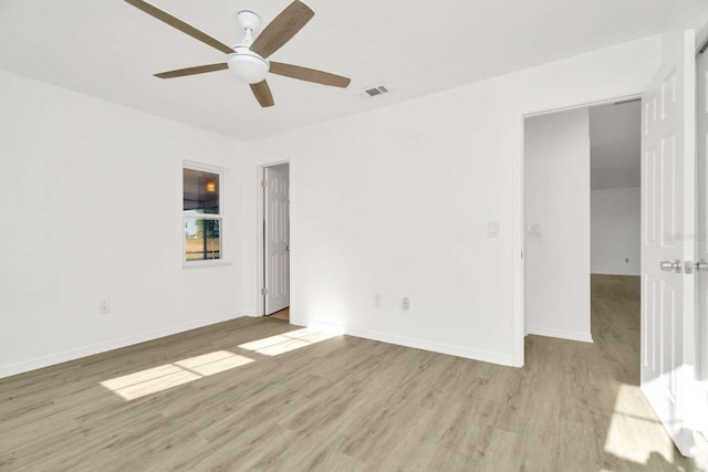 spare room with ceiling fan and light wood-type flooring