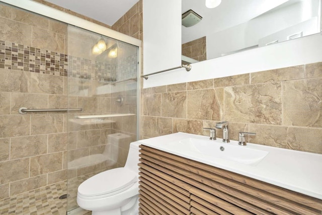 bathroom with walk in shower, tile walls, vanity, and toilet