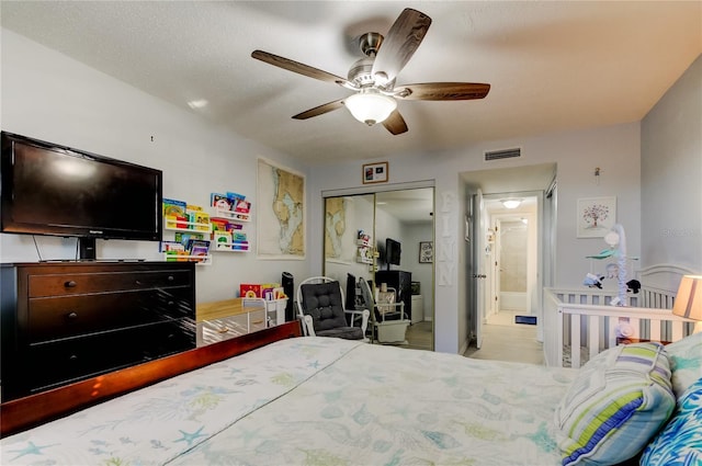 bedroom featuring ceiling fan and a closet