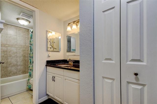 bathroom with tile patterned flooring, vanity, a textured ceiling, and shower / tub combo with curtain