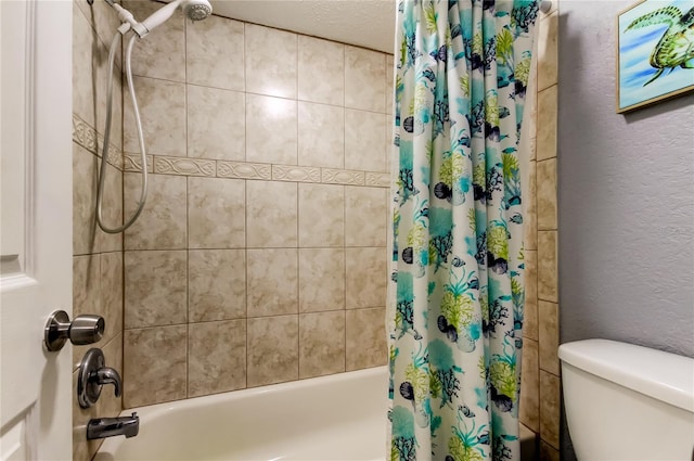 bathroom featuring shower / bathtub combination with curtain, toilet, and a textured ceiling