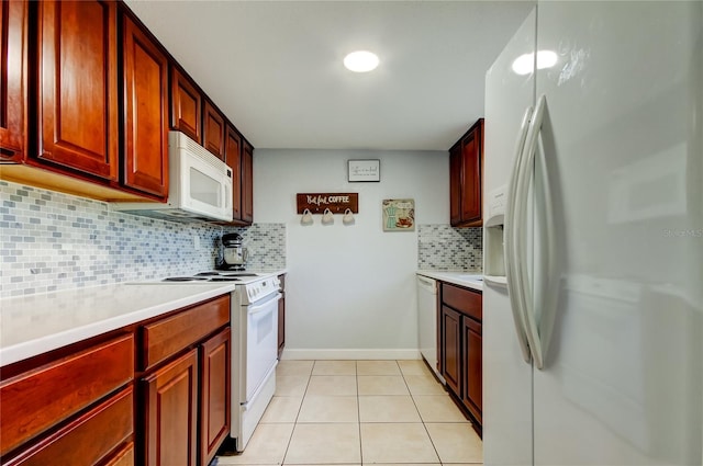 kitchen with tasteful backsplash, white appliances, and light tile patterned floors