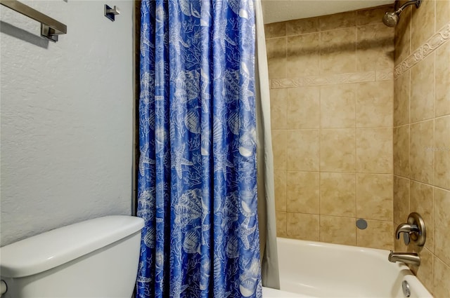 bathroom featuring shower / tub combo and toilet