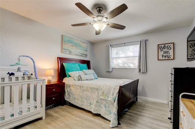 bedroom featuring light hardwood / wood-style floors and ceiling fan