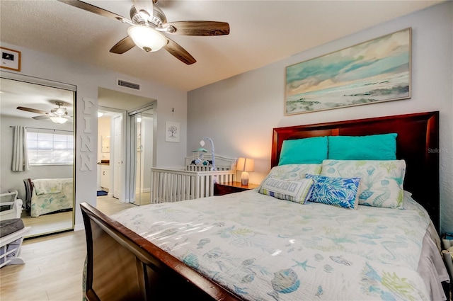 bedroom with ceiling fan and light wood-type flooring