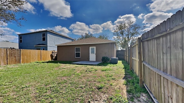 rear view of house featuring a patio, central AC unit, and a lawn