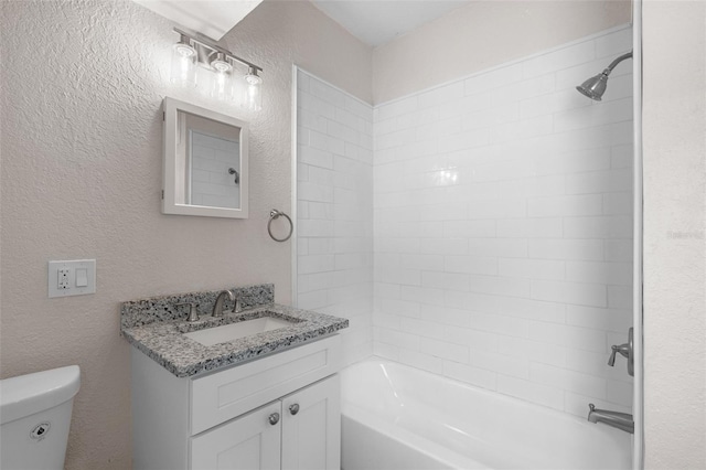 full bathroom featuring vanity, toilet, and tiled shower / bath combo