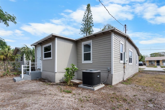 rear view of property featuring central air condition unit