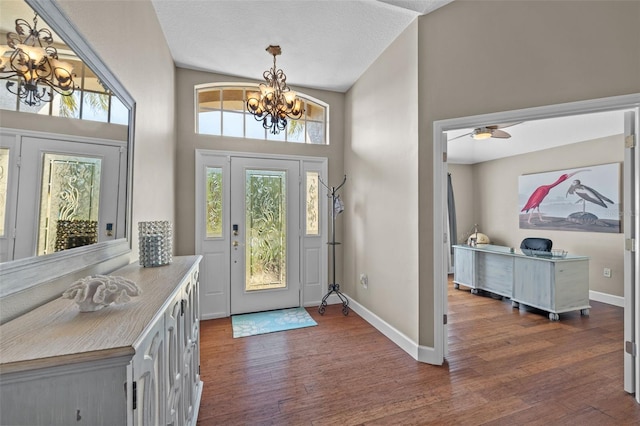 foyer featuring an inviting chandelier and dark hardwood / wood-style flooring