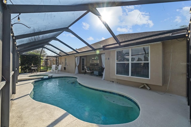 view of pool featuring a lanai, a patio, and an in ground hot tub