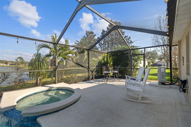 view of patio with a water view, an in ground hot tub, and glass enclosure